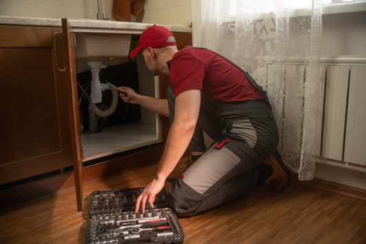Plumber Inspecting Pipe